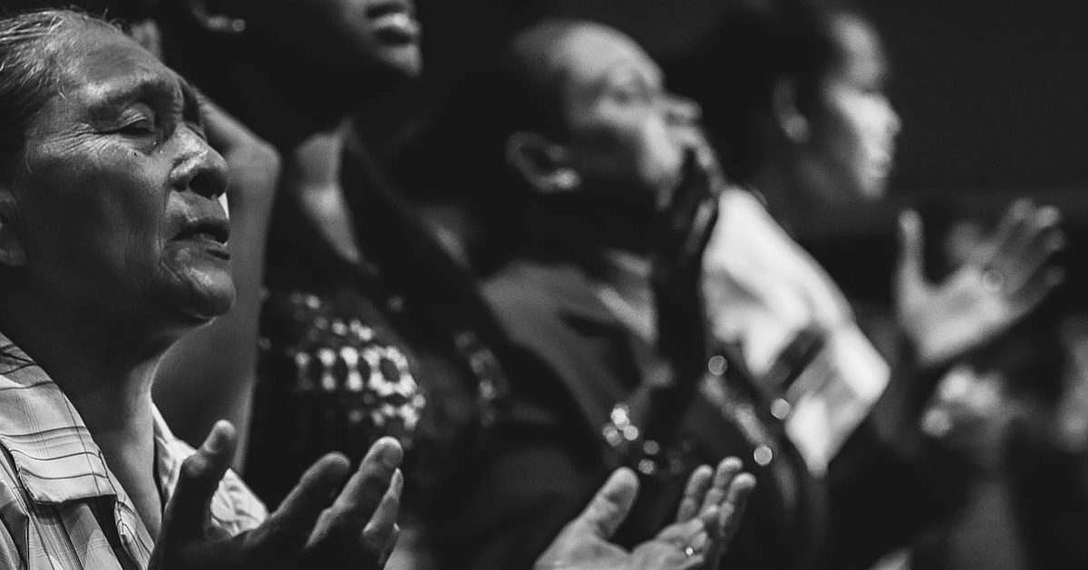 prayer: grayscale photo of people raising hands